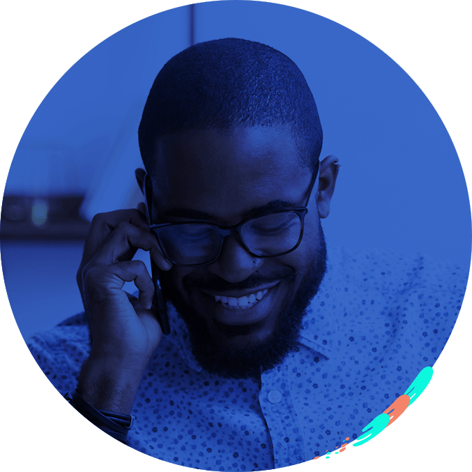 A man smiling while on the phone